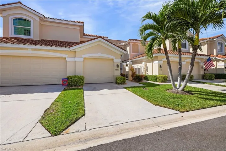 Mediterranean / spanish-style home featuring a tiled roof, concrete driveway, stucco siding, a front lawn, and an attached garage