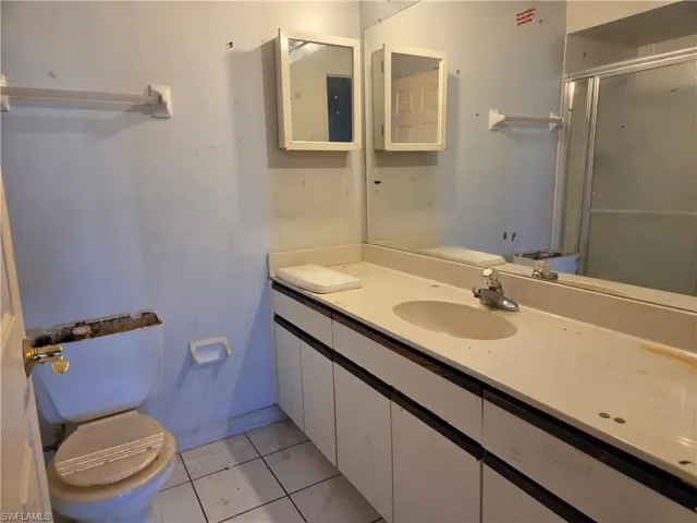Bathroom vanity with integrated sink, full-width mirror, and dual medicine cabinets