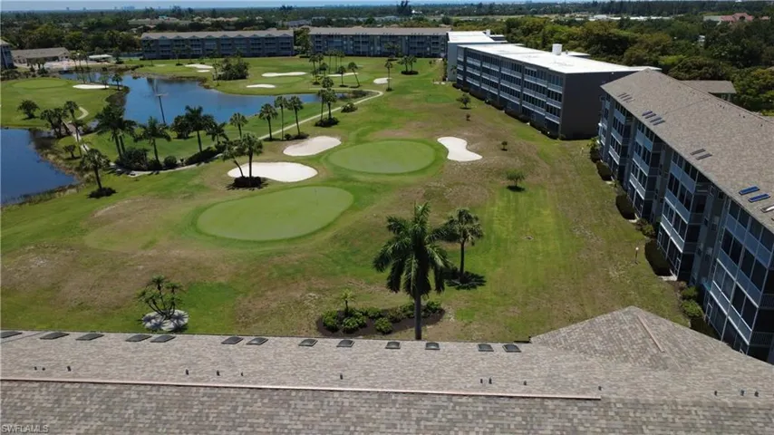 Expansive golf course setting featuring multiple greens and sand traps