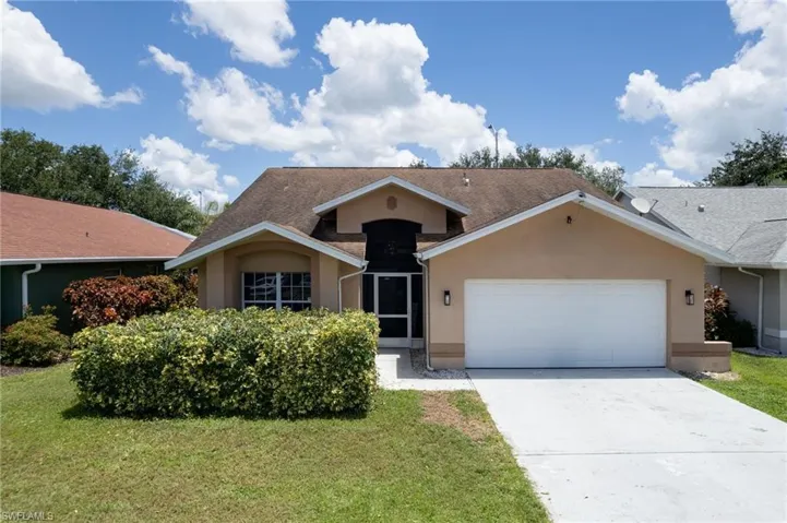 Single-story residence featuring a stucco exterior, an attached two-car garage, and a screened entry