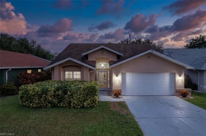 Single-story residence featuring a stucco exterior and an attached two-car garage