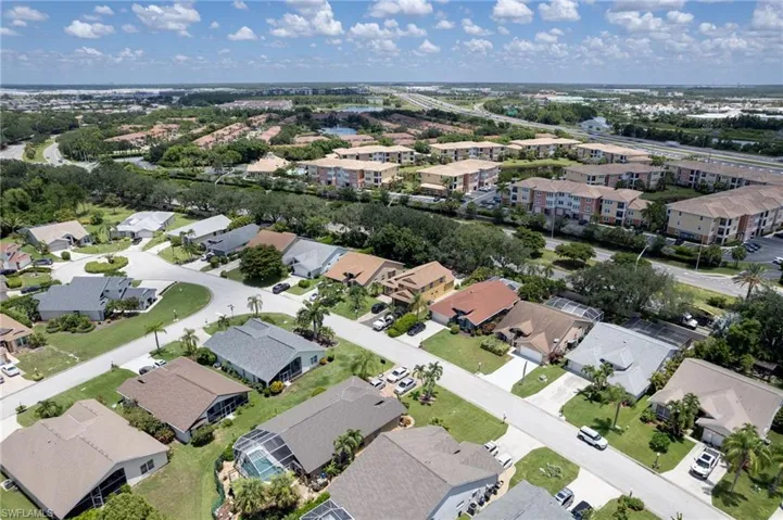 Aerial perspective showcasing a residential community with single-story homes and multi-story apartment buildings