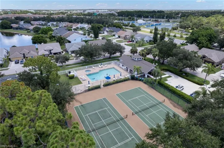Community recreation area featuring two tennis courts, a swimming pool with a spa, and a clubhouse