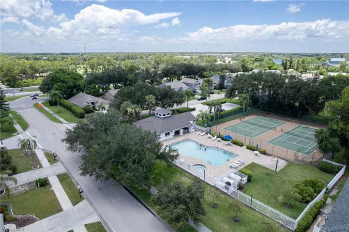 Community amenities featuring a swimming pool, clubhouse, and two tennis courts
