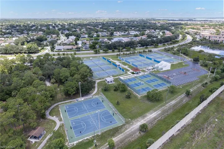 Community recreation area featuring multiple tennis courts, pickleball courts, and basketball courts