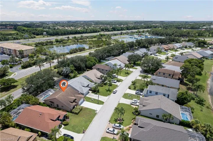 Aerial perspective showcasing a residential neighborhood with a prominent street and individual properties