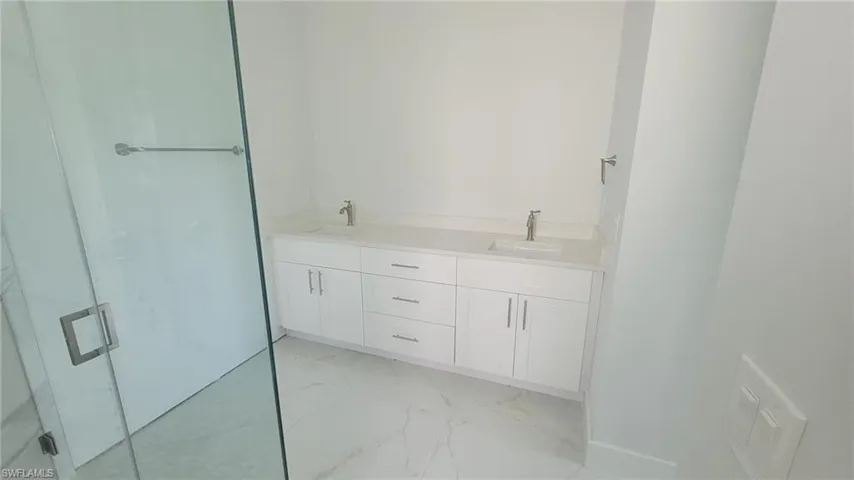 Bathroom featuring dual vanity and tile patterned flooring
