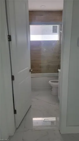 Full bathroom featuring a healthy amount of sunlight, vanity, tile patterned flooring, and toilet