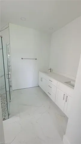 Bathroom featuring tile patterned floors and dual bowl vanity