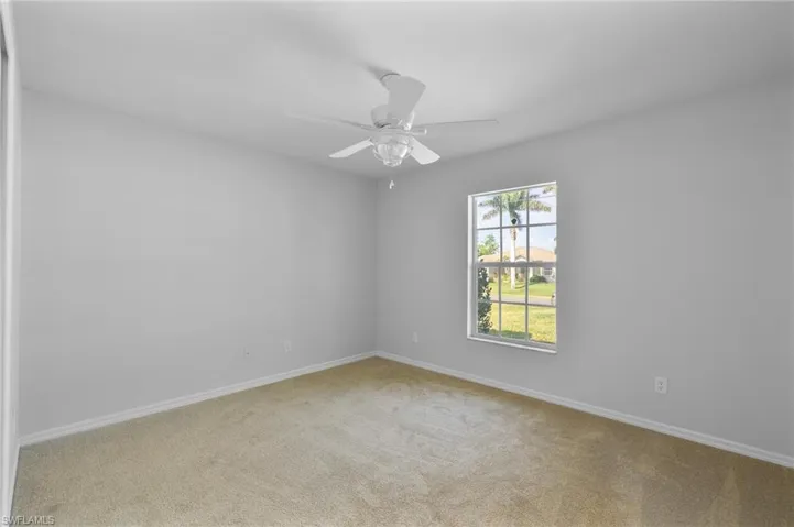 Front bedroom on opposite side of primary suite with new ceiling fan