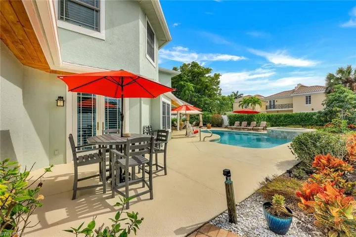 View of swimming pool with a patio, outdoor dining area, and a pool with connected hot tub