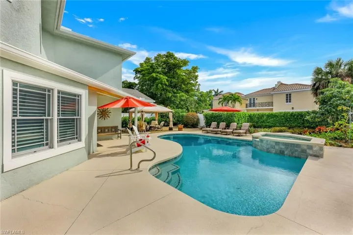 View of pool featuring a patio and a pool with connected hot tub