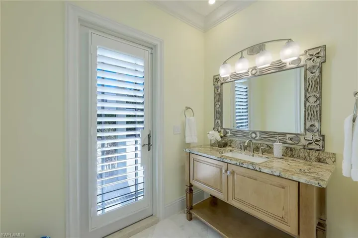 Bathroom featuring vanity and crown molding