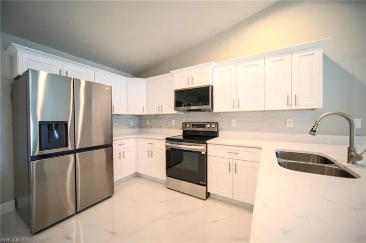 The Kitchen Comes With Quartz Countertops, Tile Backsplash, Stainless Steel Appliances, And White Soft Touch Wooden Cabinets With Brushed Nickle Handles!