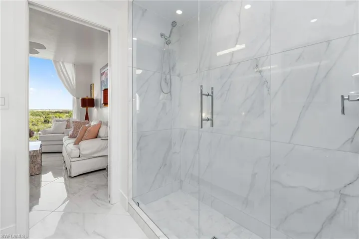 Ensuite bathroom with a marble finish shower