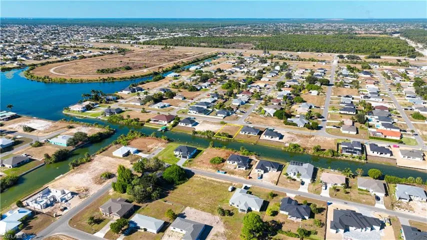 Aerial overview of property's location with nearby suburban area and a nearby body of water