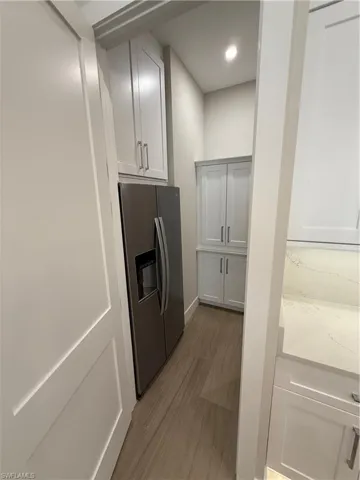 Butler pantry with refrigerator and built-in cabinets