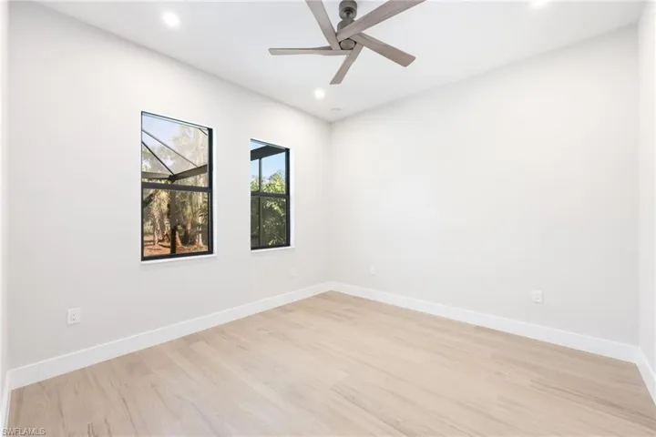 Empty room with light hardwood / wood-style floors and ceiling fan