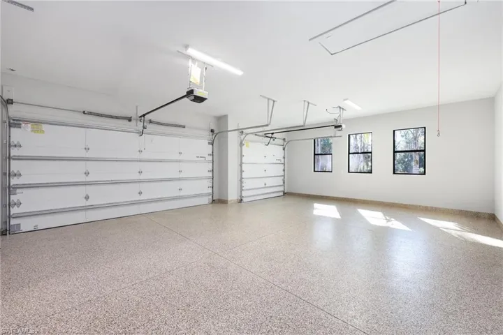 Three car garage with epoxy floors and pull down stairs