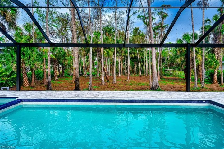 View of pool with glass enclosure