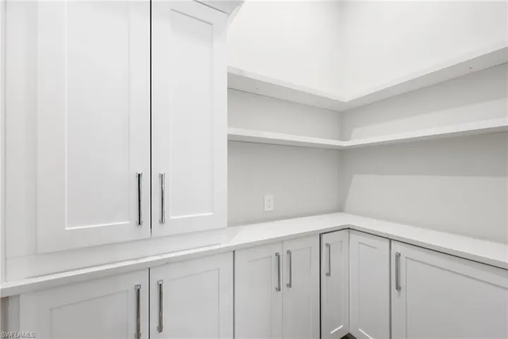 View of butler pantry with extra refrigerator