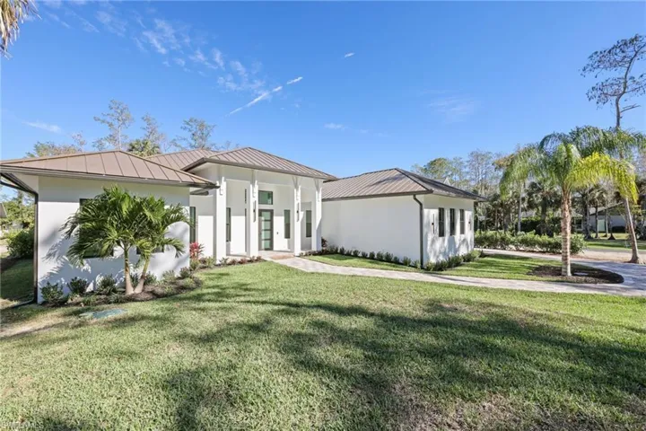 View of front of home with a front lawn/metal roof