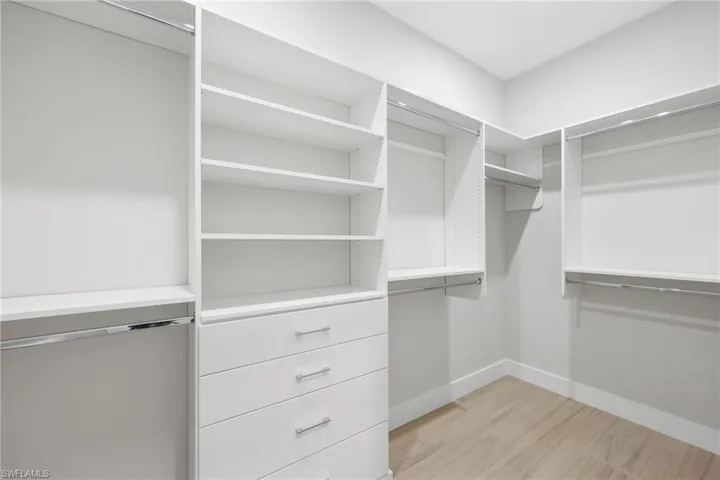 Two walk in closets with built-ins