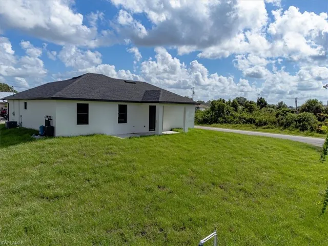 Rear view of property featuring a yard