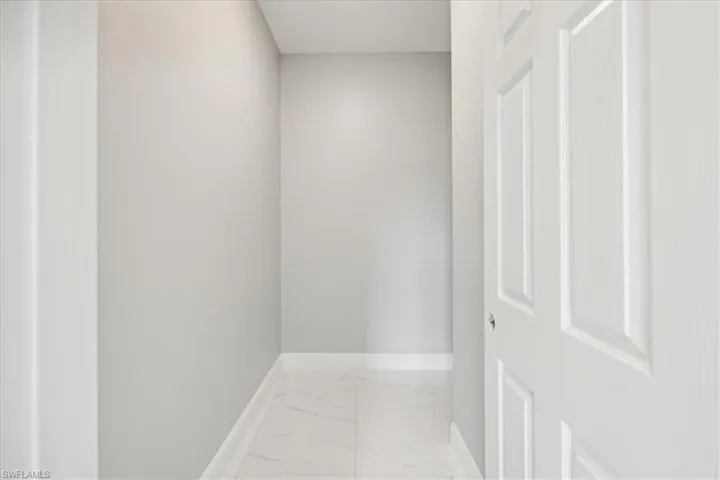 Hall featuring tile patterned flooring