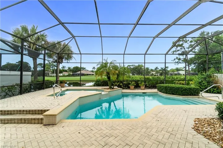 Large lanai with views of the 5th hole on the Golf course and a large lake. You got it all.