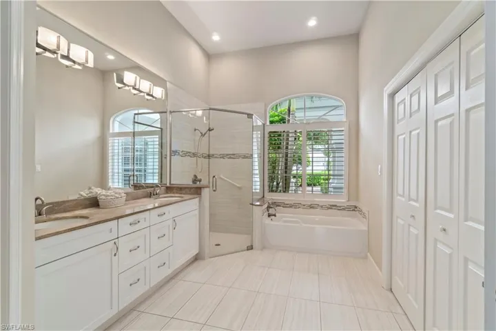 Large primary bath with separate toilet area, double sinks, shower, bath and walk in closet.