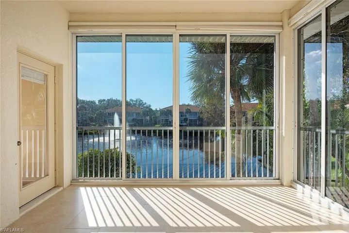 Unfurnished sunroom featuring a water view
