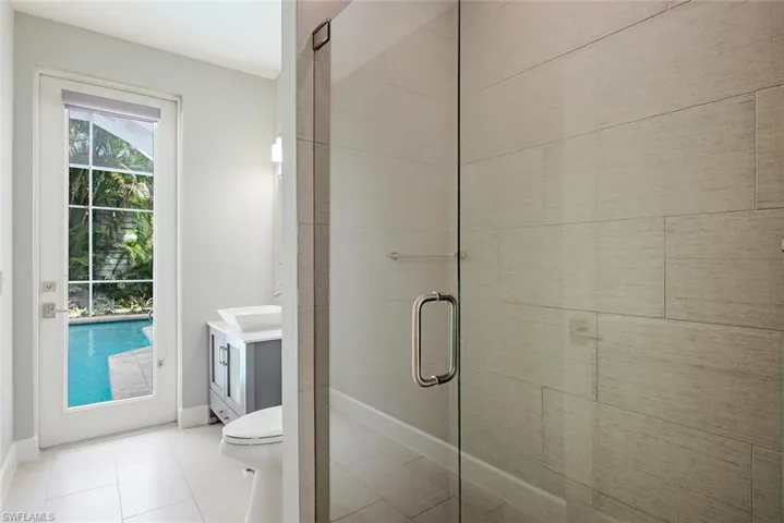 Bathroom featuring a healthy amount of sunlight, tile patterned floors, vanity, and toilet