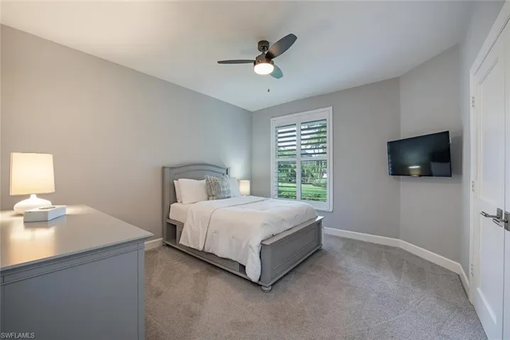 Carpeted bedroom with ceiling fan