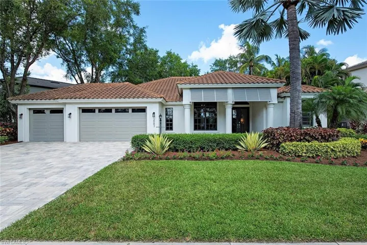 Mediterranean / spanish house with a garage and a front yard