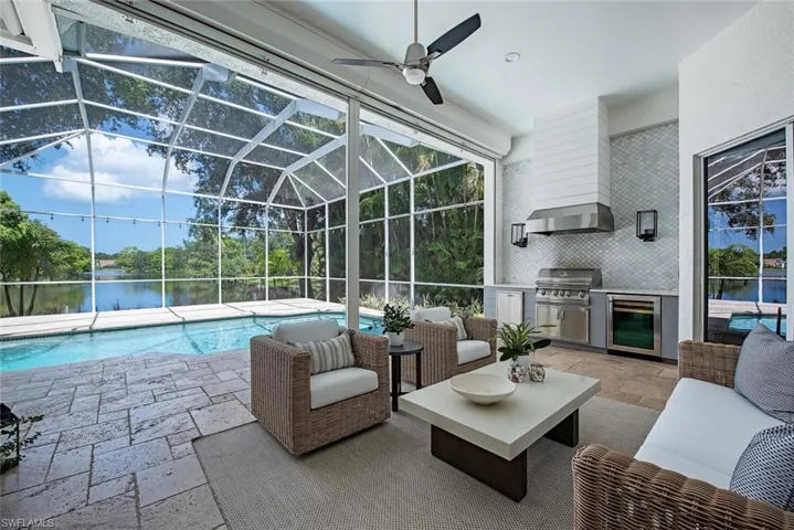 View of swimming pool with built in grilling area and beer fridge.