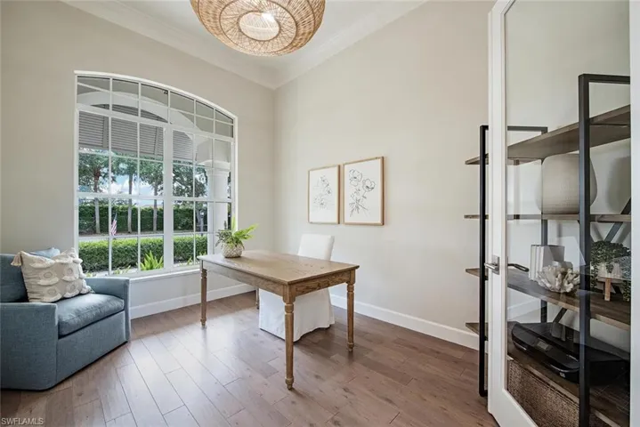 Home office featuring hardwood / wood-style flooring and crown molding