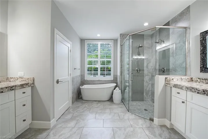 Bathroom with vanity, tile patterned flooring, and independent shower and bath