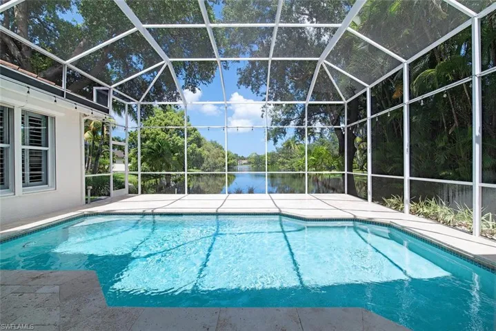 View of pool with screen enclosure.