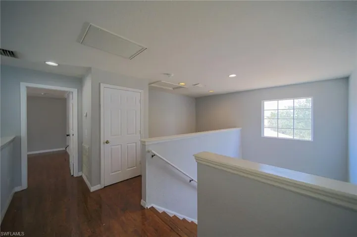 Corridor featuring dark hardwood / wood-style floors