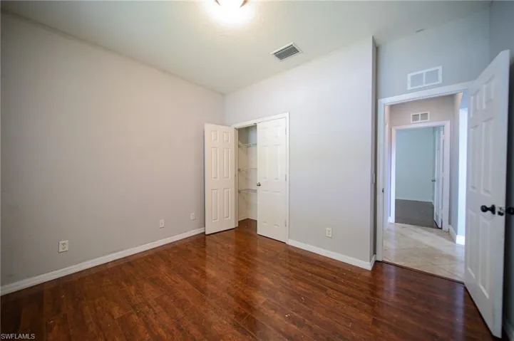 Unfurnished bedroom featuring wood-type flooring and a closet