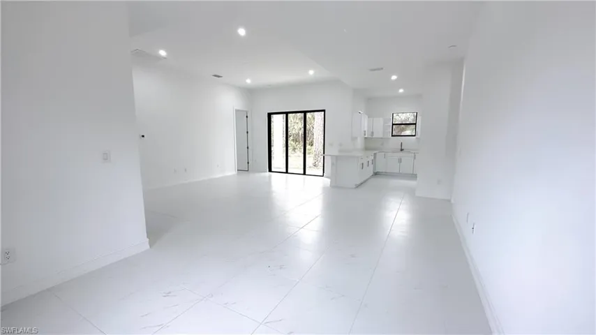 Unfurnished room featuring baseboards and recessed lighting