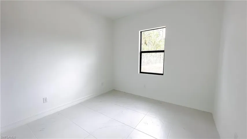 Empty room with light marble finish floors and baseboards