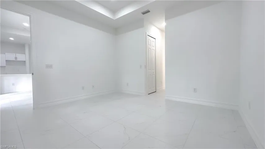 Unfurnished room with light marble finish flooring and recessed lighting