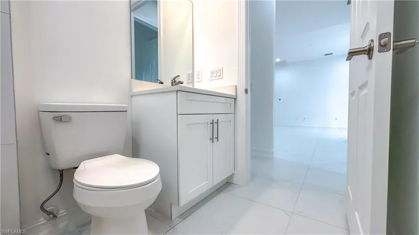 Bathroom featuring vanity and marble finish floors