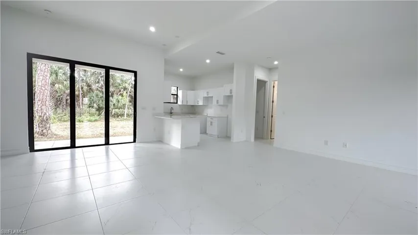 Unfurnished living room with recessed lighting