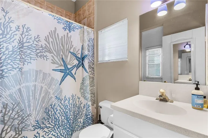 Full bathroom with vanity and a shower with curtain