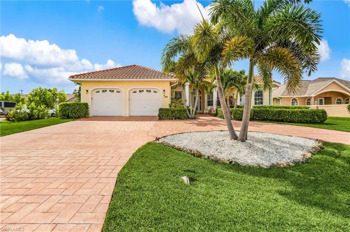 Mediterranean / spanish-style house featuring decorative driveway, stucco siding, a front yard, and an attached garage
