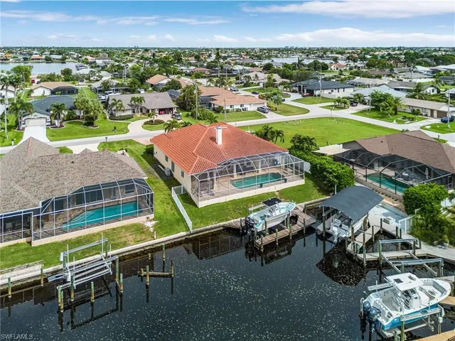 Aerial view of residential area featuring a large body of water