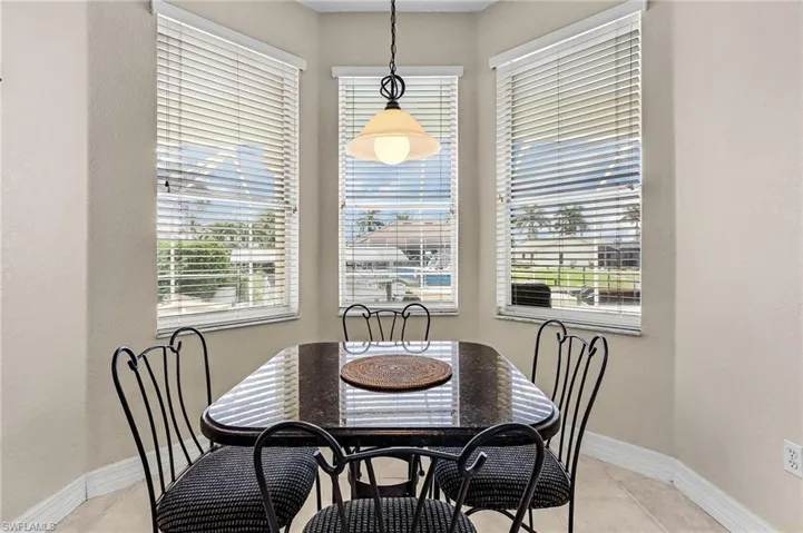 Dining room with light tile patterned floors and a textured wall
